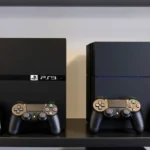 PlayStation 3 and PlayStation 4 consoles displayed side by side on a gaming shelf with controllers, showing the generational difference in console design and hardware