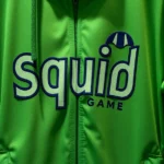 Close-up of authentic green Squid Game contestant tracksuit hanging on display, photorealistic fabric texture, professional retail lighting, no text visible