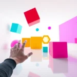 First-person perspective showing colorful 3D geometric shapes floating in an abstract minimalist space with clean white background, player hand reaching toward objects, bright neon colors reflecting off surfaces, photorealistic rendering, gaming environment